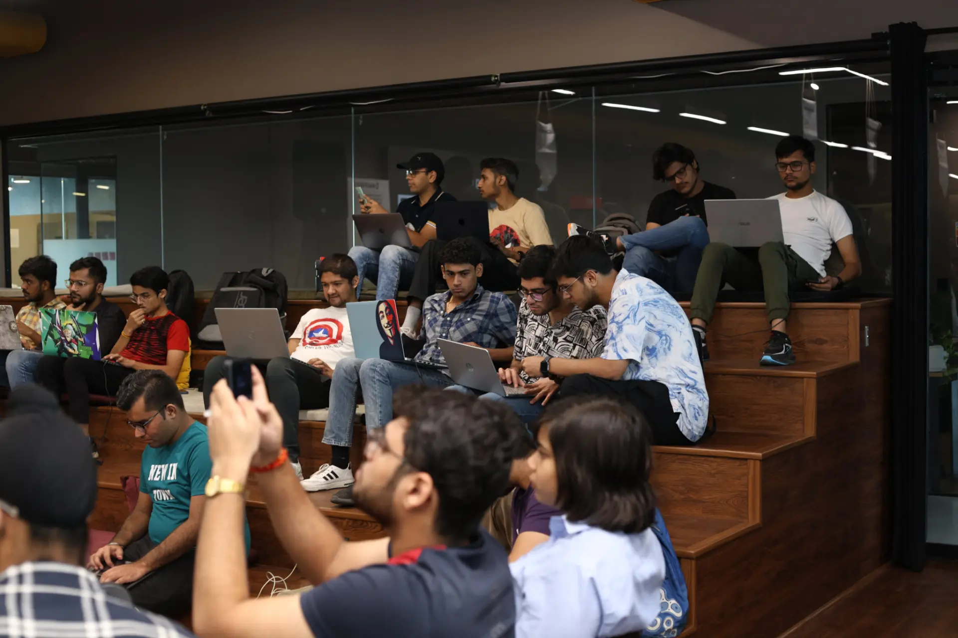 Developers working on laptops in tiered seating during a builder session